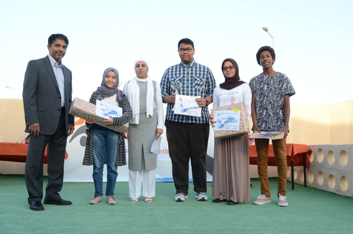 Students receiving award certificates on stage